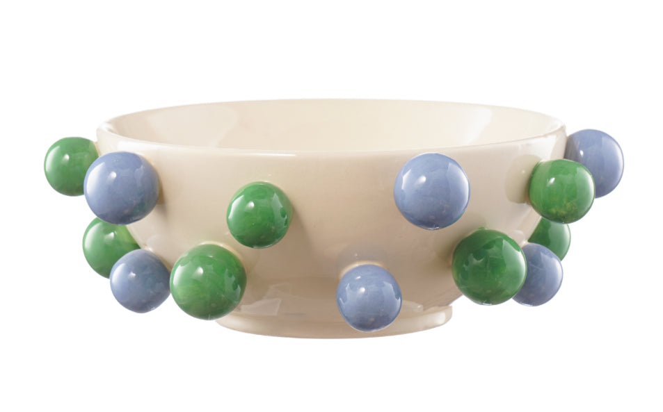 Decorative bowl with green and blue spherical embellishments on a white background